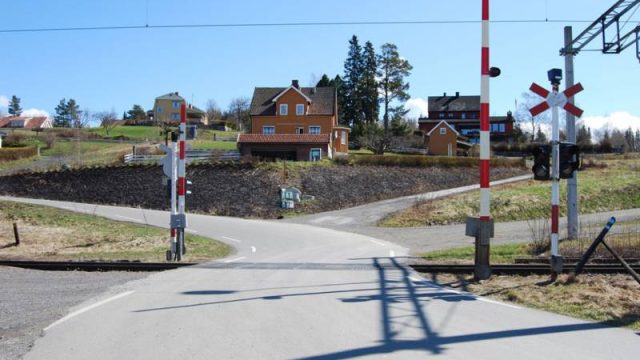 Jernbaneovergang ved Bleiken stasjon (Fotograf: Solfrid Myhre, (c) Arkivnett Oppland) Bilde av jernbaneovergang bilvei på Bleiken stasjon