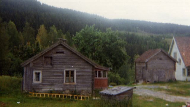 Plassen Olimbsbråten i Jevnaker – Foto: Randsfjordmuseene AS Eldre bygg med skur og noe nyere hus i bakgrunnen